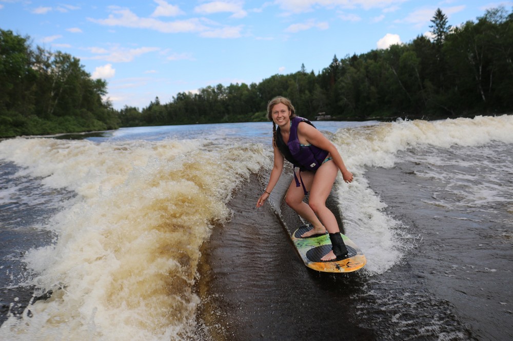 Maia wake surfing on a lake in Timmins