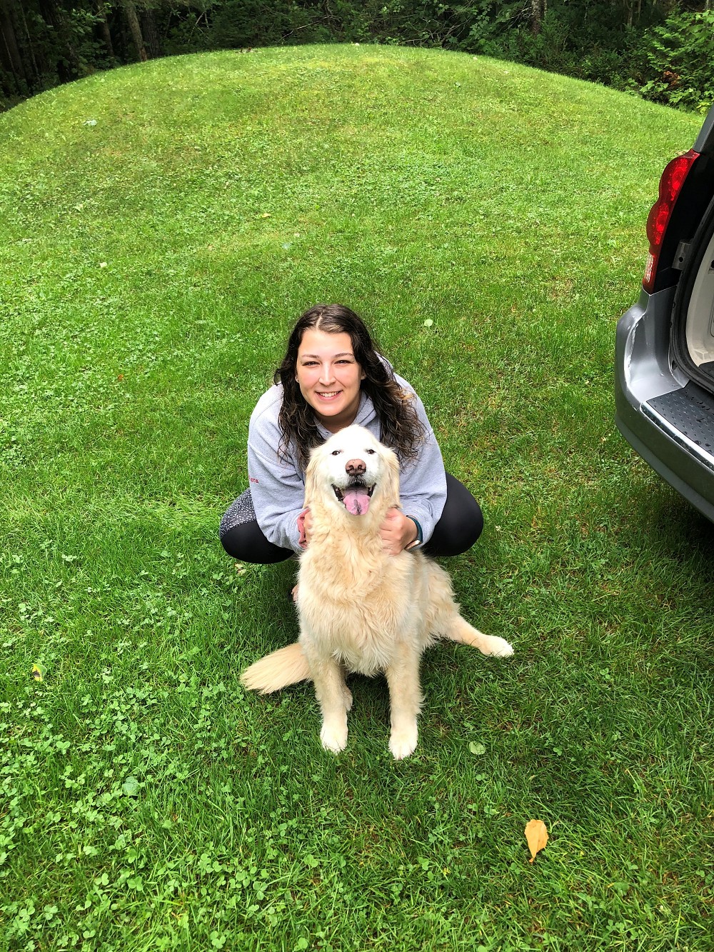 Christina camping with her golden retriever