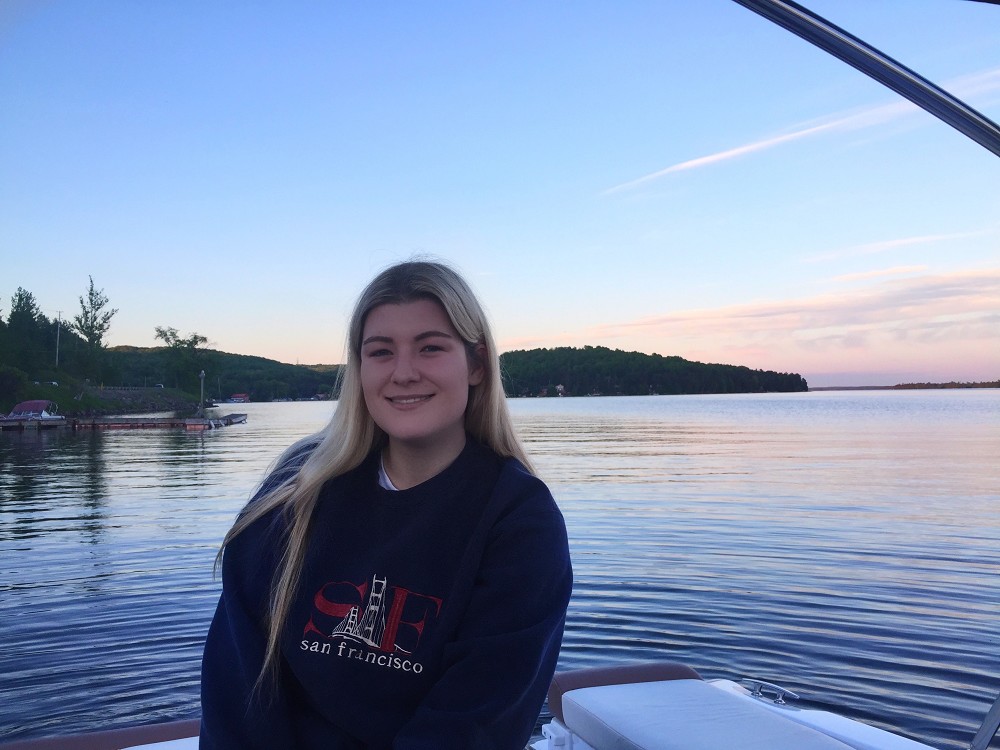 Mercedes sitting in a boat at sunset